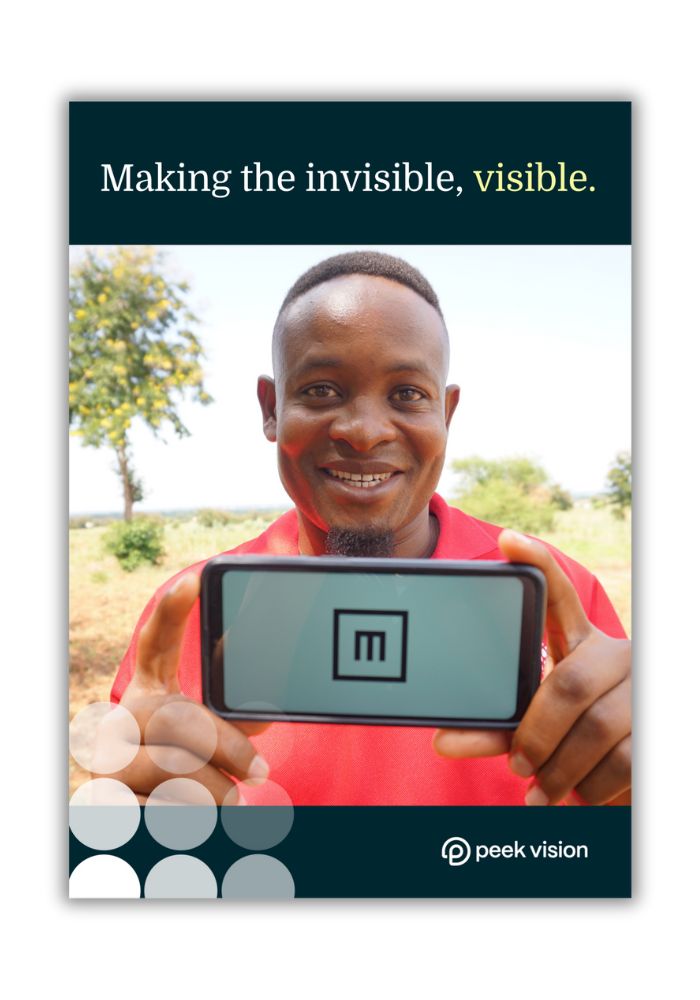 Cover of the Peek Vision brochure, showing a man holding up a phone displaying the Peek app with 'tumbling E'.