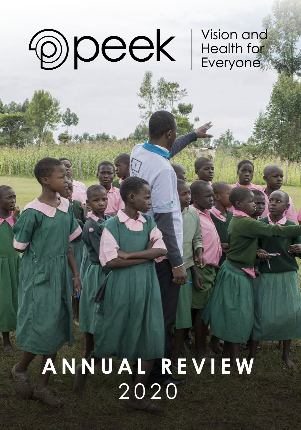 A group of school children stand in a playground in front of and around a health worker with the Peek logo on his back. In front of the photo reads "Peek: Vision and Health for Everyone Annual Review 2020."
