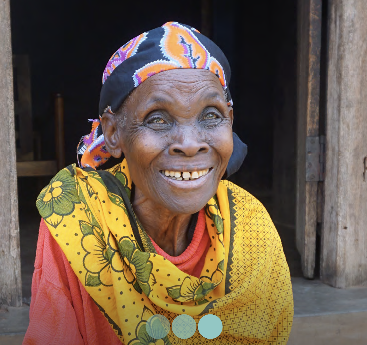 Teodosia smiles outside her rural village home on the front cover of the Annual Review 2022 for Peek Vision.