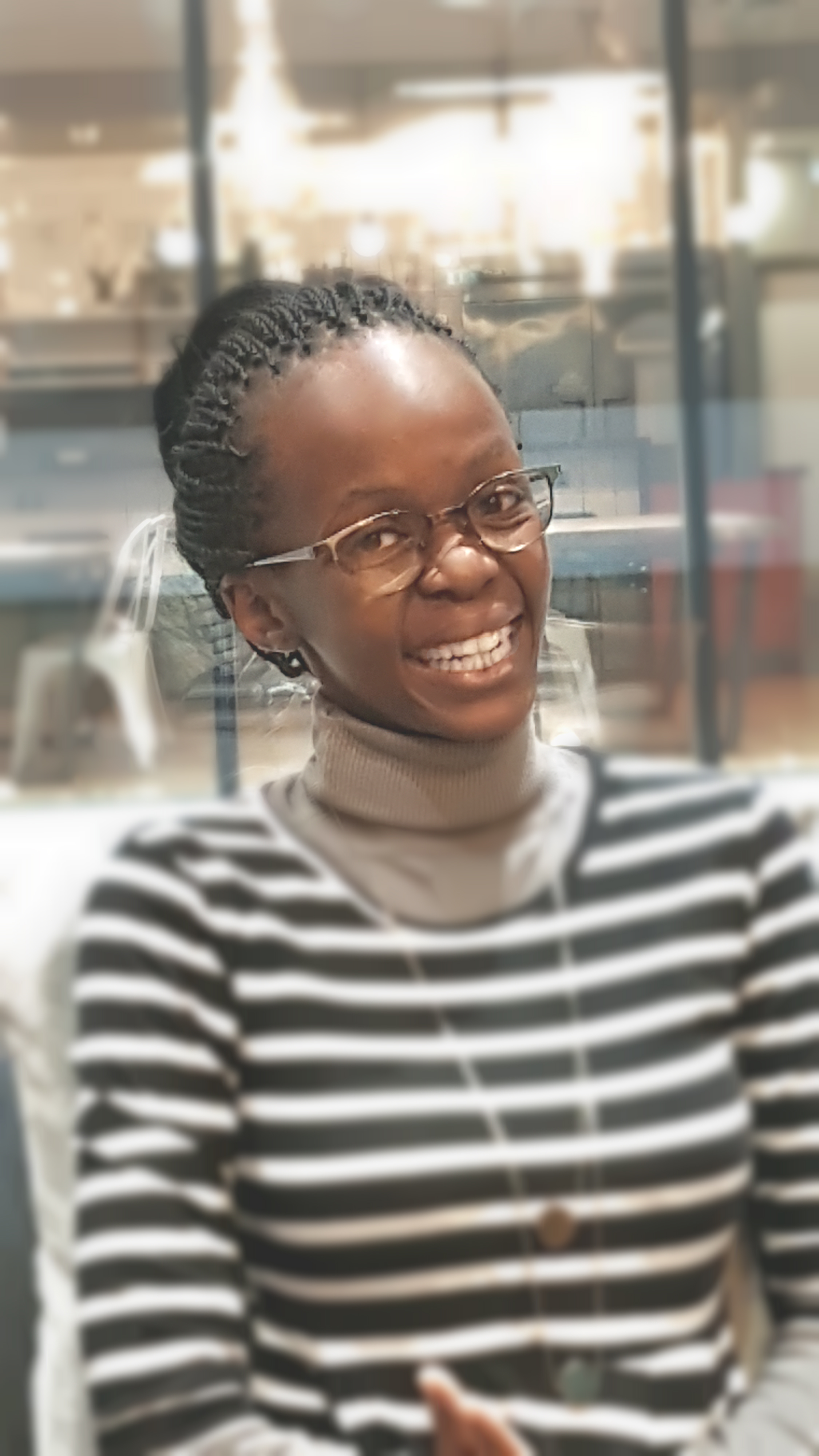 A picture of Keitumetse Thamane, a young black woman in a sweatshirt, smiling.