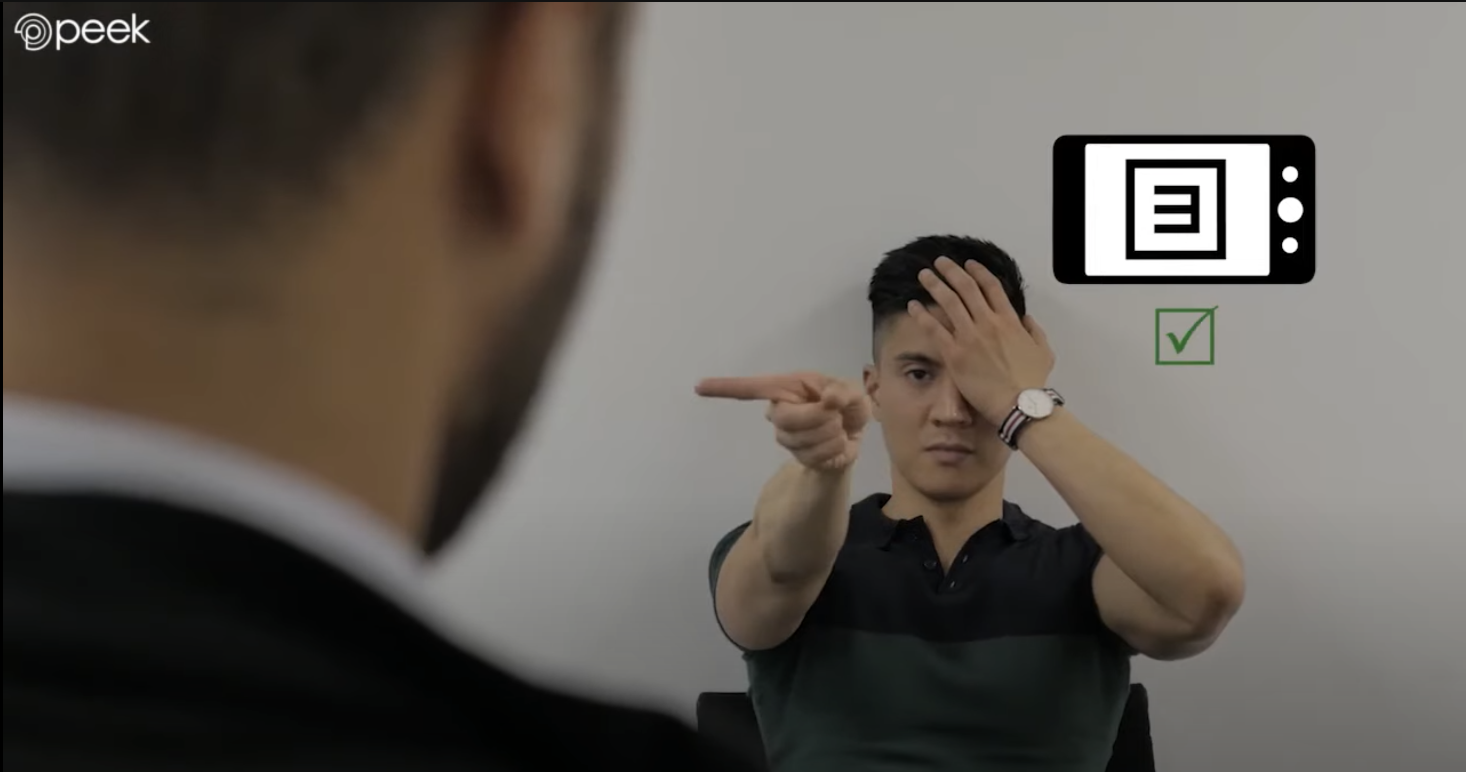 Screenshot from Peek Acuity tutorial video showing someone having their vision screened using the app.