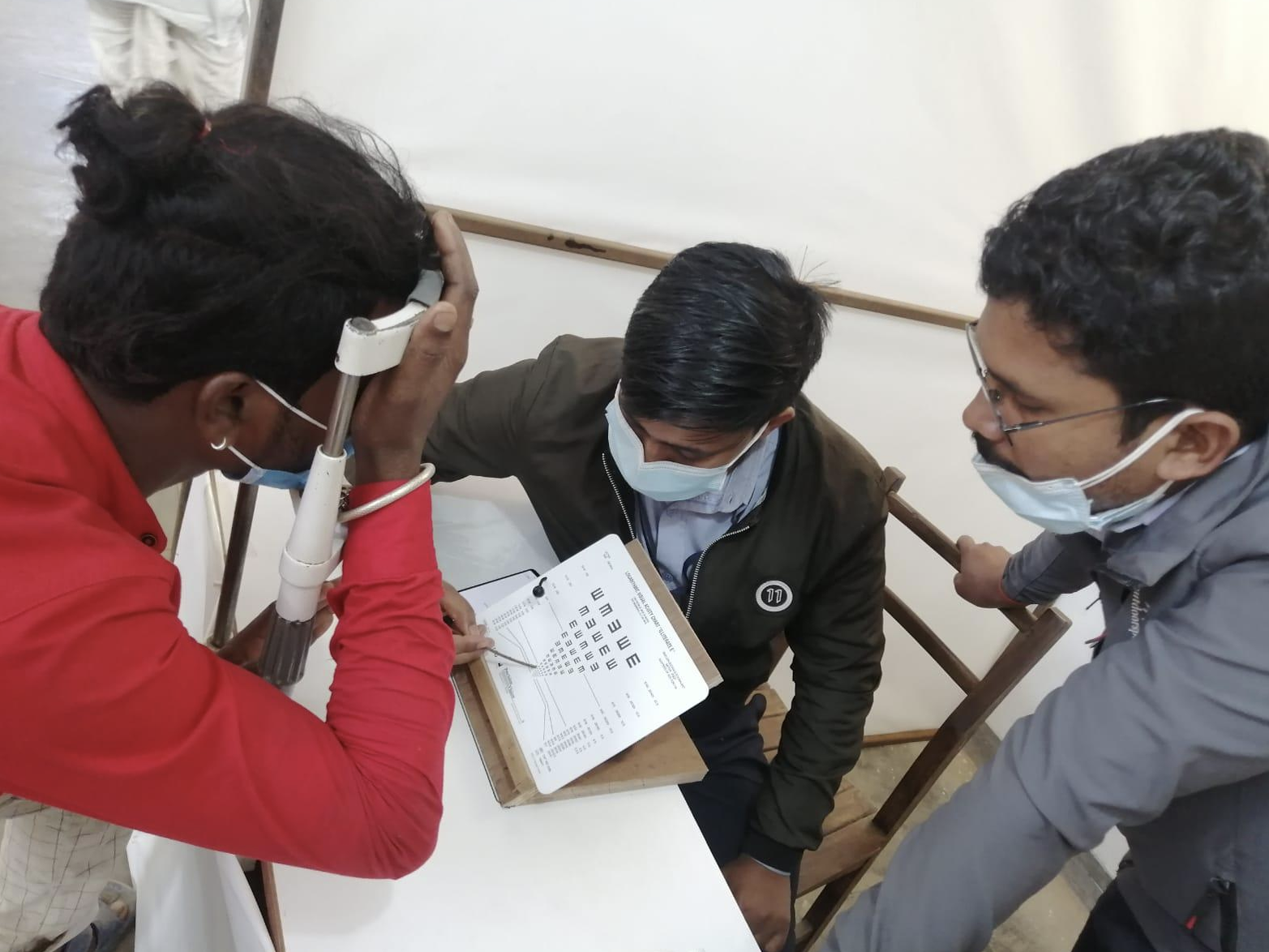 A woman has her vision tested using a chart as part of the validation study for the Peek Vision near vision test in Nepal.