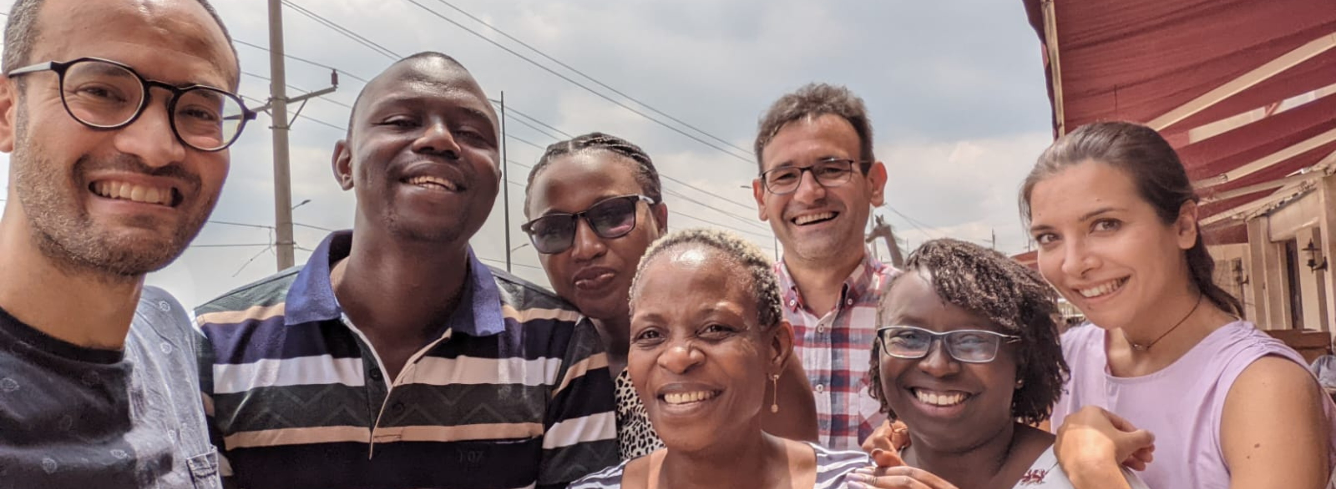 A group of Peek team members smile for a selfie photo.