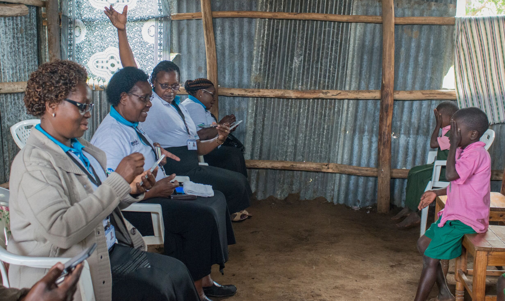 3 women conducting eye tests on children