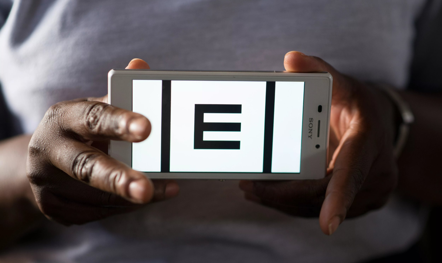 A person holding Peek smartphone app