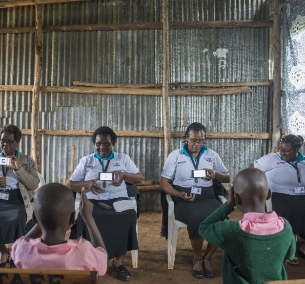 Children in Kenya having their vision assessed with Peek's smartphone visual acuity test.