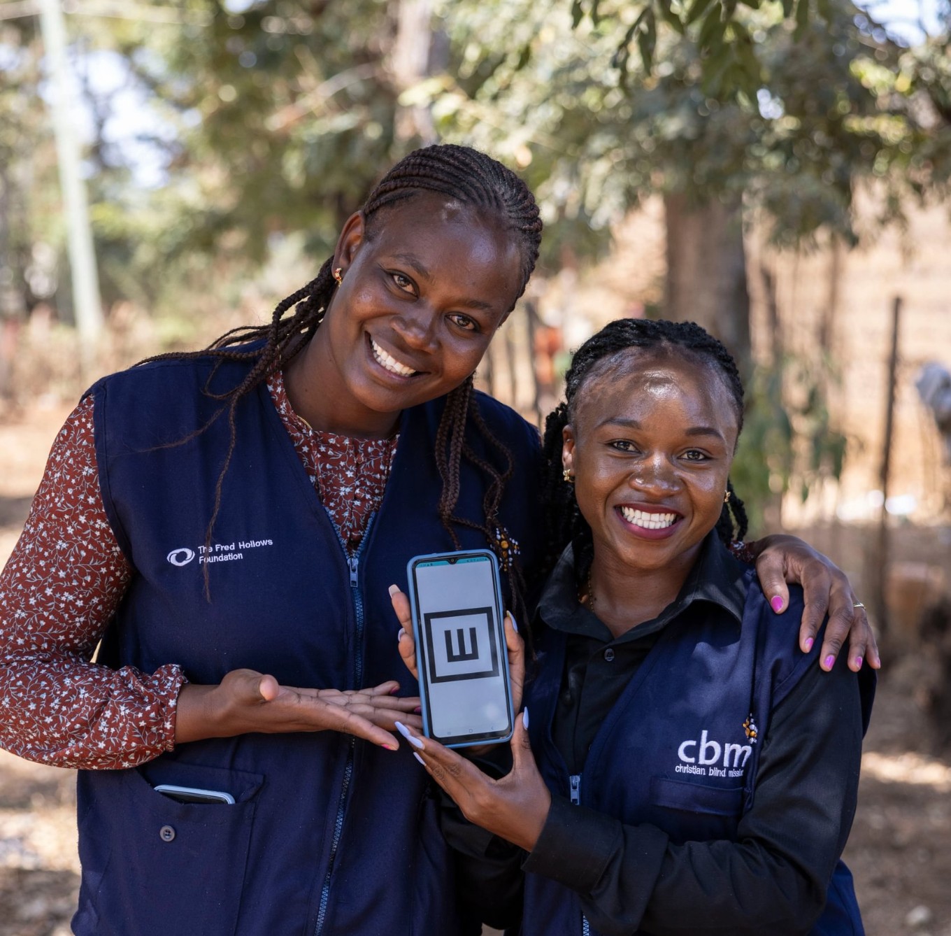 Two women holding the Peek app